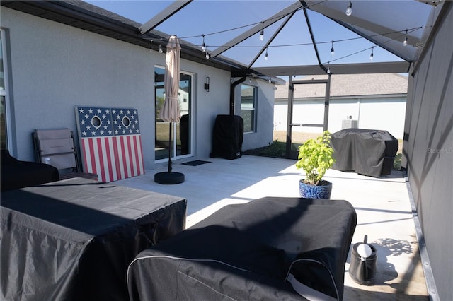 view of patio with a lanai and grilling area