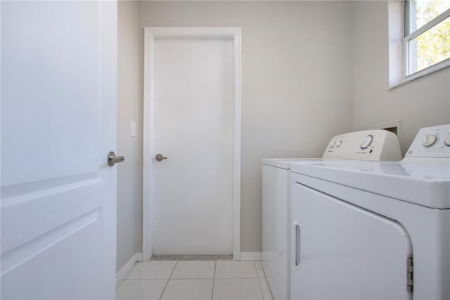 laundry area featuring independent washer and dryer and light tile patterned floors