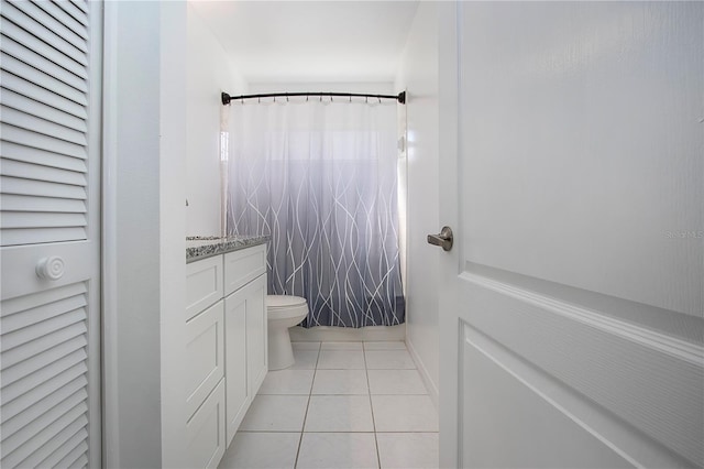 bathroom featuring vanity, toilet, and tile patterned flooring