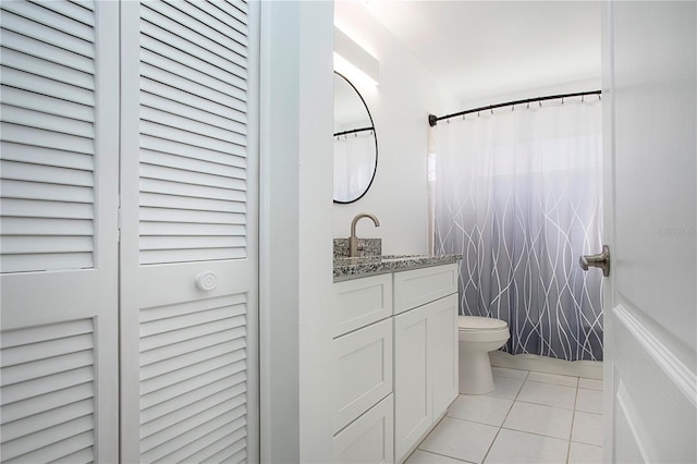 bathroom with a shower with shower curtain, vanity, toilet, and tile patterned flooring