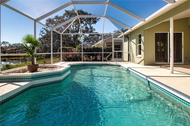 view of swimming pool featuring a patio, glass enclosure, and a water view