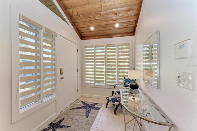 tiled foyer featuring lofted ceiling and wooden ceiling