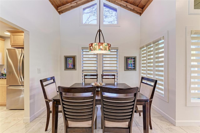 dining space with wooden ceiling and high vaulted ceiling