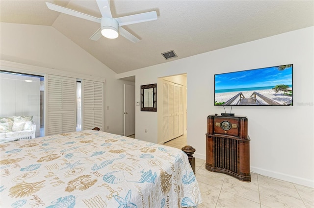 bedroom featuring ceiling fan, lofted ceiling, a closet, and a textured ceiling