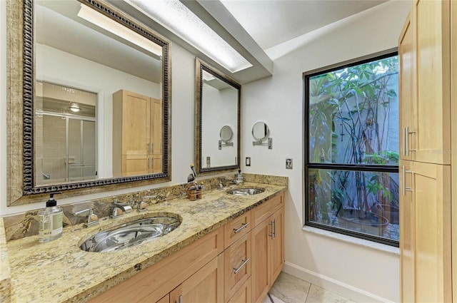 bathroom with tile patterned flooring, vanity, and an enclosed shower