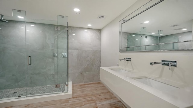 bathroom featuring recessed lighting, visible vents, a shower stall, and wood finished floors