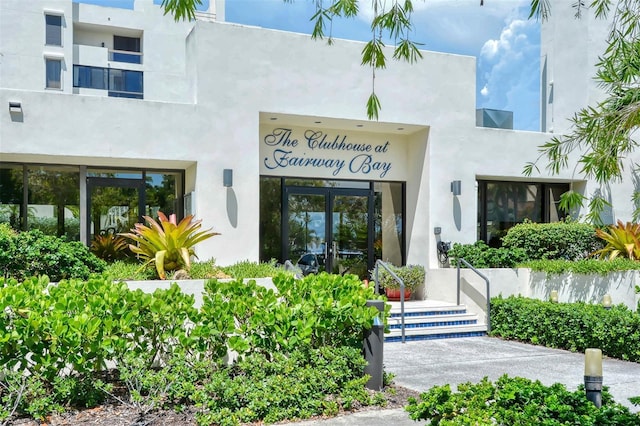 property entrance with french doors and stucco siding