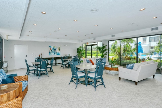 interior space featuring a textured ceiling, visible vents, and recessed lighting