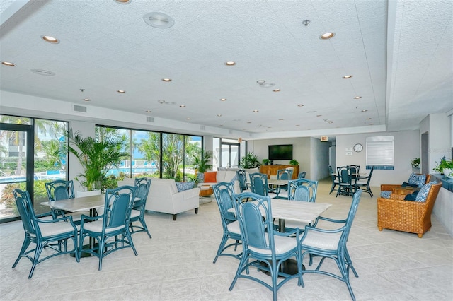 dining area with visible vents, a textured ceiling, and recessed lighting