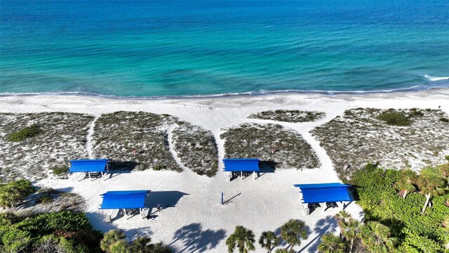 drone / aerial view with a beach view and a water view