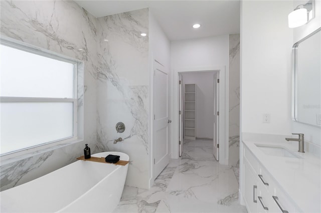 bathroom featuring vanity and a bath