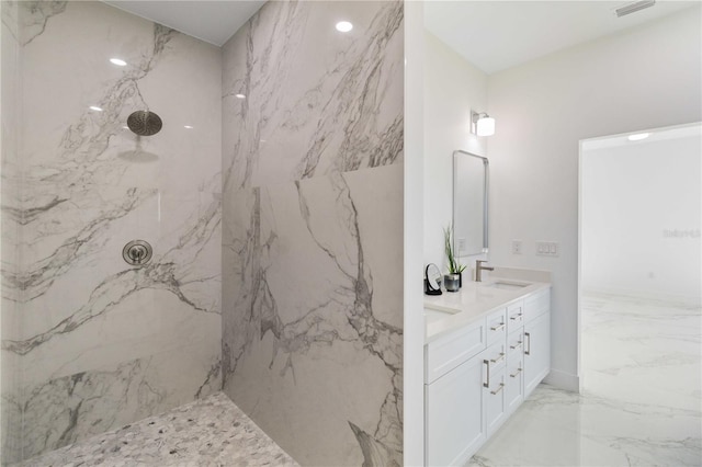 bathroom with vanity and tiled shower