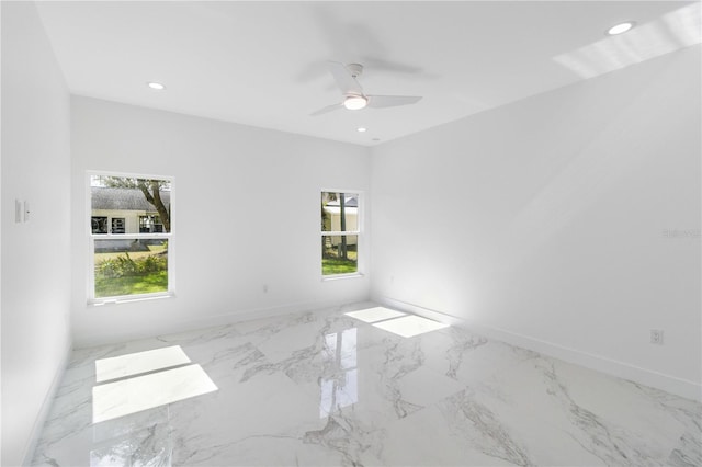 unfurnished room featuring a wealth of natural light and ceiling fan