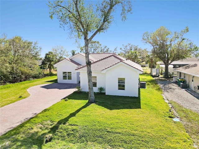 view of home's exterior featuring central AC and a lawn