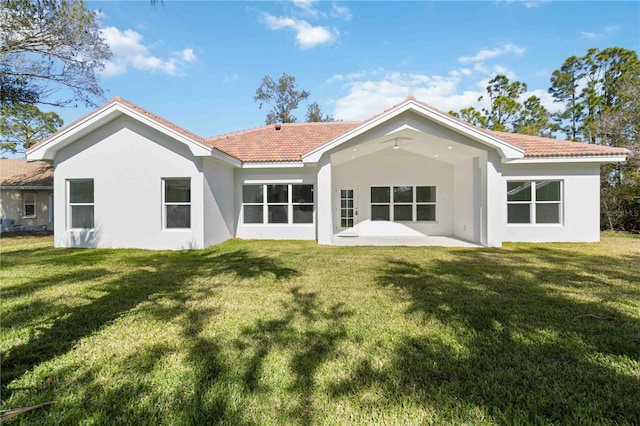 rear view of house with a patio and a yard