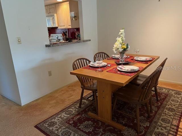 dining area featuring carpet flooring