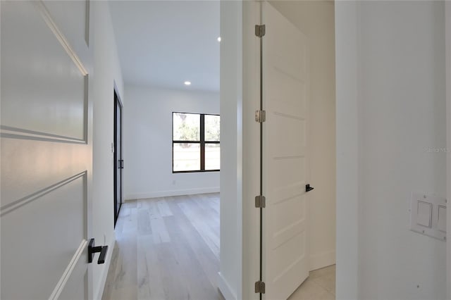 hallway with light hardwood / wood-style floors