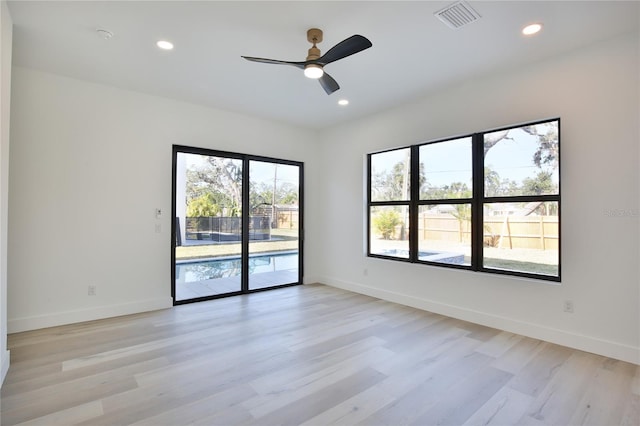 unfurnished room with ceiling fan and light hardwood / wood-style flooring