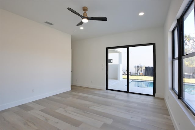 spare room featuring ceiling fan and light wood-type flooring