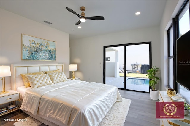 bedroom with access to exterior, hardwood / wood-style floors, and ceiling fan