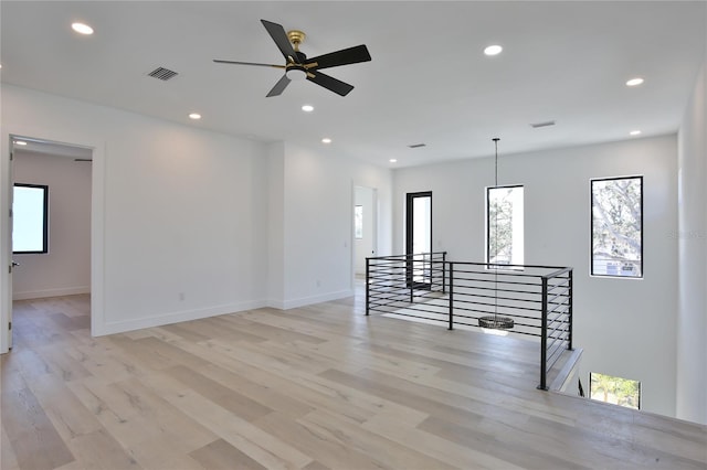 empty room featuring ceiling fan and light wood-type flooring