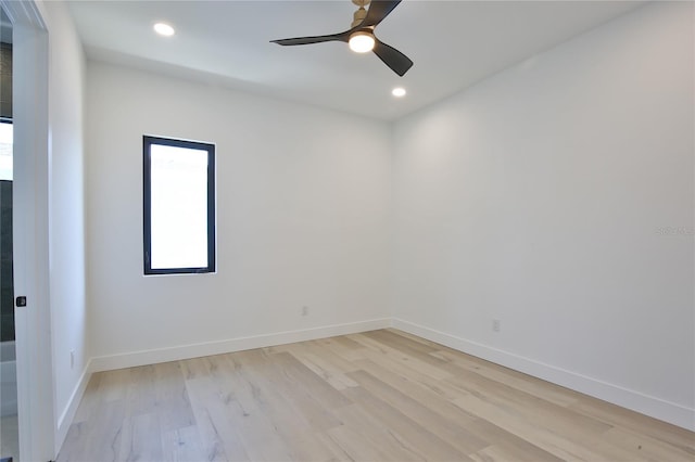 spare room featuring light hardwood / wood-style floors and ceiling fan