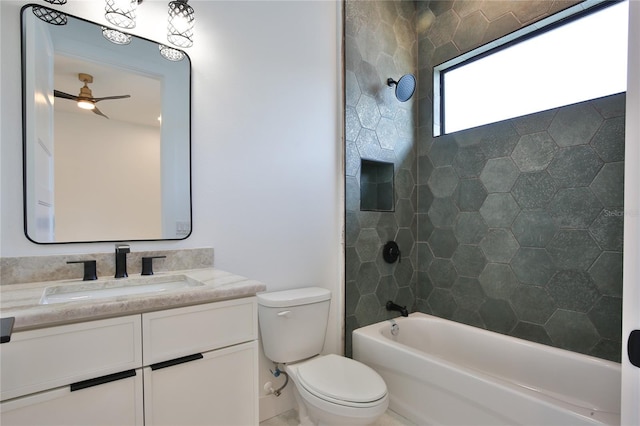 full bathroom featuring vanity, ceiling fan, tiled shower / bath combo, and toilet