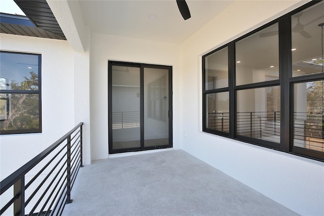 view of patio featuring ceiling fan and a balcony