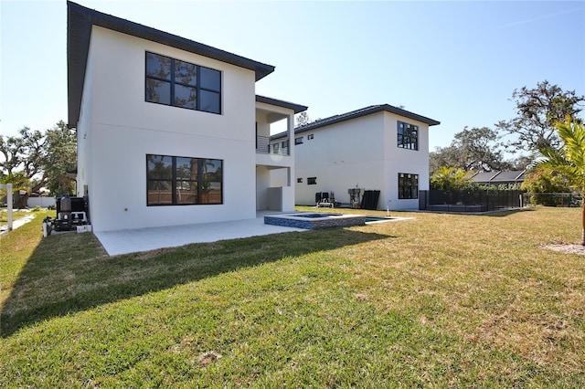 back of property featuring a patio area and a lawn