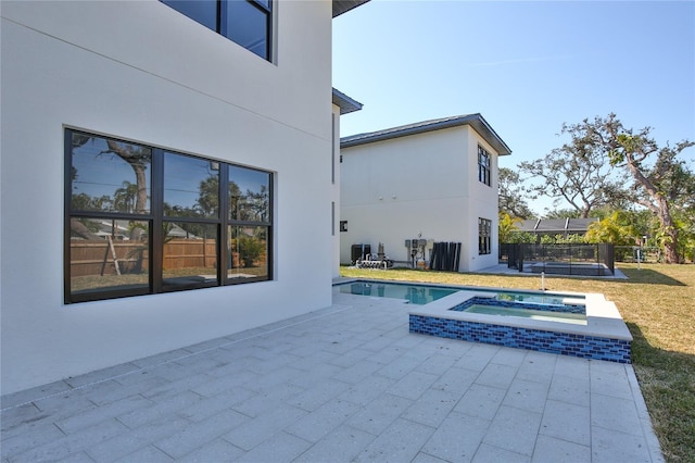 view of pool with an in ground hot tub and a patio area