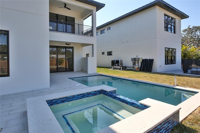 view of swimming pool with a yard, a patio area, ceiling fan, and an in ground hot tub