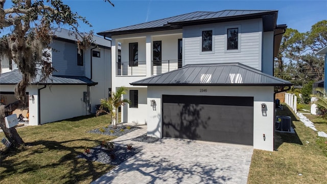 view of front of house featuring a balcony, a front yard, and central air condition unit