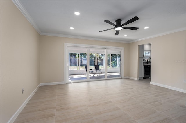 spare room with crown molding, ceiling fan, and sink