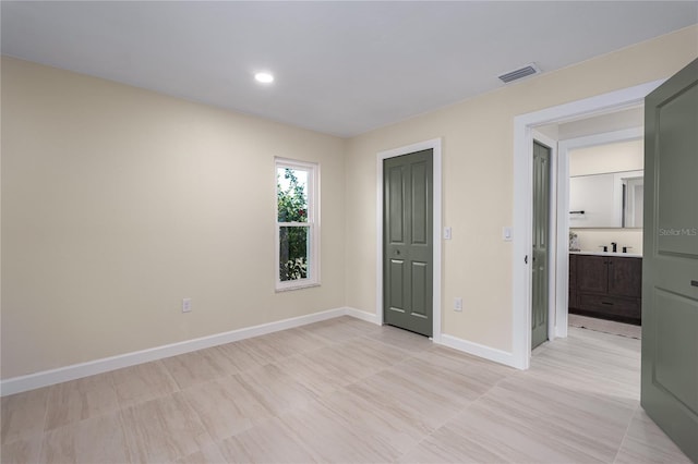 unfurnished bedroom with ensuite bathroom