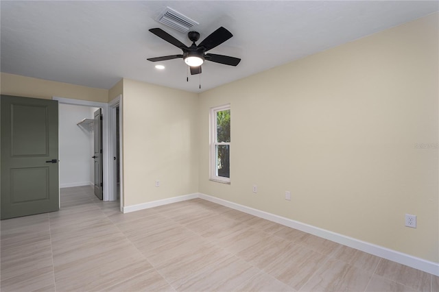 unfurnished bedroom featuring a walk in closet, ceiling fan, and a closet