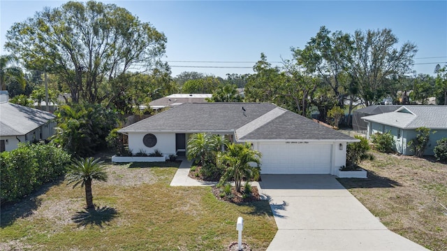 ranch-style house featuring a garage and a front yard