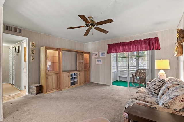 living room with ceiling fan and carpet flooring