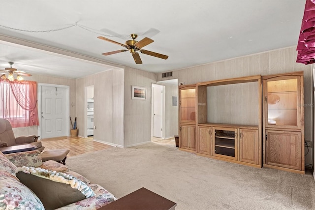 carpeted living room featuring ceiling fan