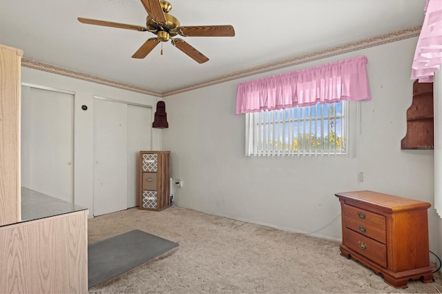 interior space featuring ceiling fan and light colored carpet