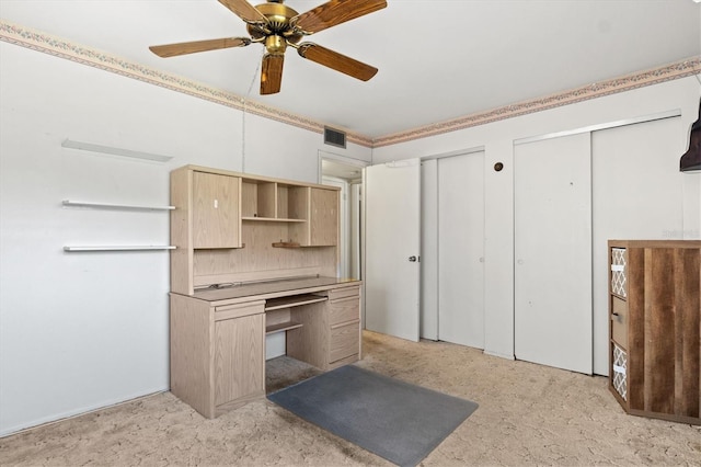 kitchen featuring light brown cabinets and ceiling fan