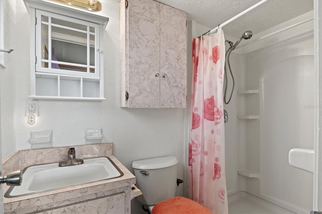 bathroom featuring vanity, toilet, a textured ceiling, and walk in shower