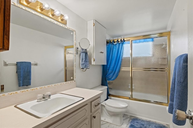 full bathroom featuring enclosed tub / shower combo, vanity, and toilet