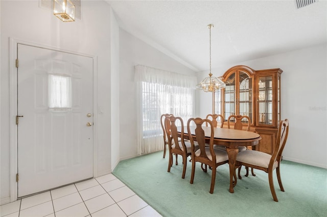 tiled dining space with a notable chandelier, vaulted ceiling, and a textured ceiling
