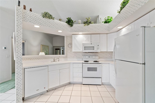 kitchen with sink, light tile patterned floors, backsplash, white appliances, and white cabinets