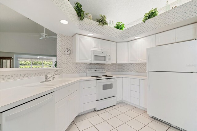 kitchen with sink, white cabinets, light tile patterned floors, ceiling fan, and white appliances