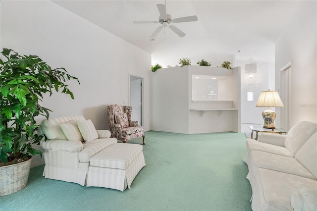 living room with lofted ceiling, carpet flooring, and ceiling fan