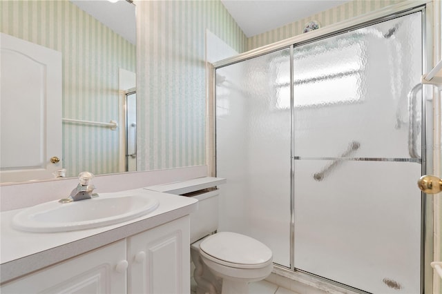 bathroom with walk in shower, vanity, and toilet