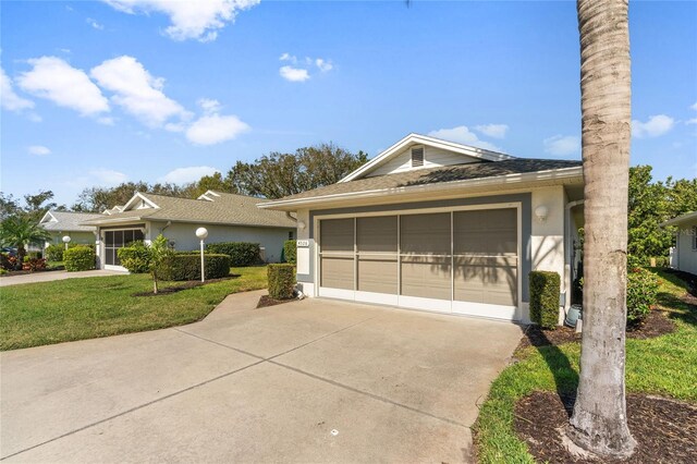 single story home featuring a garage and a front yard