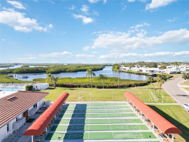 view of property's community featuring a water view and a yard