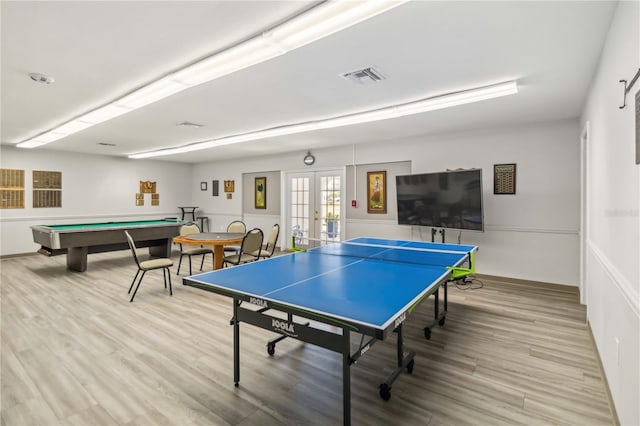 recreation room featuring french doors and light hardwood / wood-style flooring
